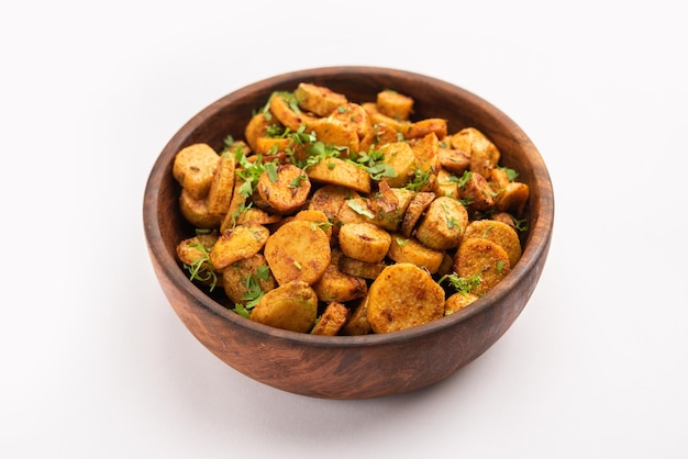 Stir fried taro roots arbi ki sabji ghuiya masala curry sabzi\
or arvi dum masala garnished with coriander