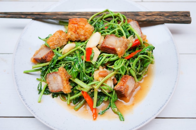 Stir-fried water mimosa with crispy pork