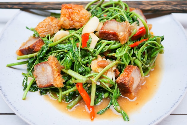 Stir-fried water mimosa with crispy pork