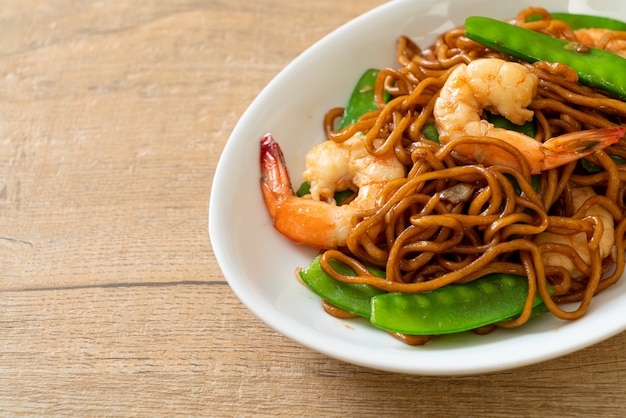 stir-fried yakisoba noodles with green peas and shrimps - Asian food style