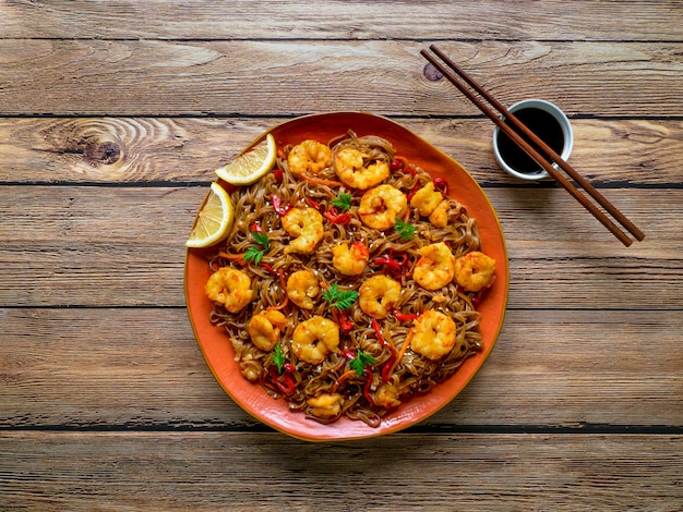 Stir fry noodles with fried shrimps, vegetables and soy sauce