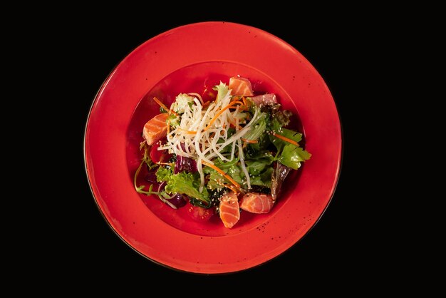 Stir fry noodles with vegetables and shrimps in black bowl Slate background Top view Copy space