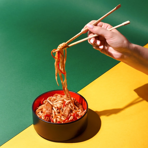 Stir fry soba noodles with beef and vegetables in wok on dark background, Asian udon noodles with beef WOK in black bowl on Slate background. Copy space with hard shadows