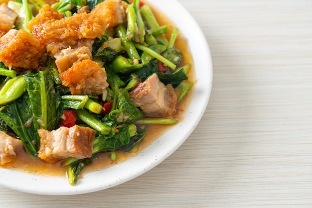 Stirfried kale vegetable with crispy pork