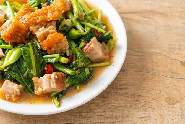 Stirfried kale vegetable with crispy pork