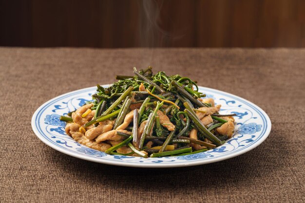 Stirfried meat with mountain bracken on a monochrome background