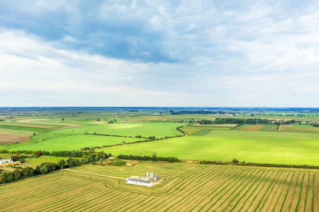 Stitched Panorbeautiful view from a great height on colorful fields, against the background of the summer blue sky, summer landscape with a drone, green fieldama