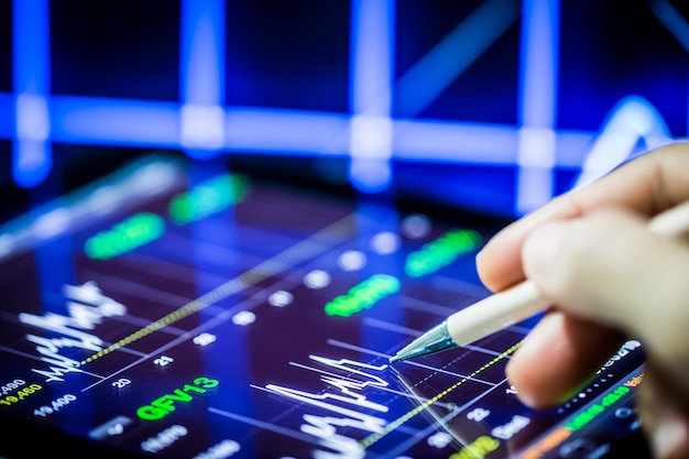 Stock analysis with digital tablet and hand pointing