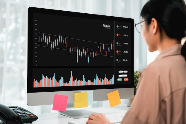 Stock exchange market concept, business people trader looking computer with graphs analysis candle line on table in office, diagrams on screen.