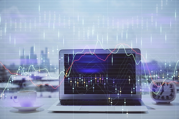 Stock market graph on background with desk and personal computer Multi exposure Concept of financial analysis