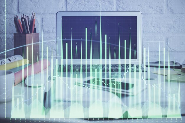 Foto grafico del mercato azionario sullo sfondo con scrivania e personal computer esposizione multipla concetto di analisi finanziaria