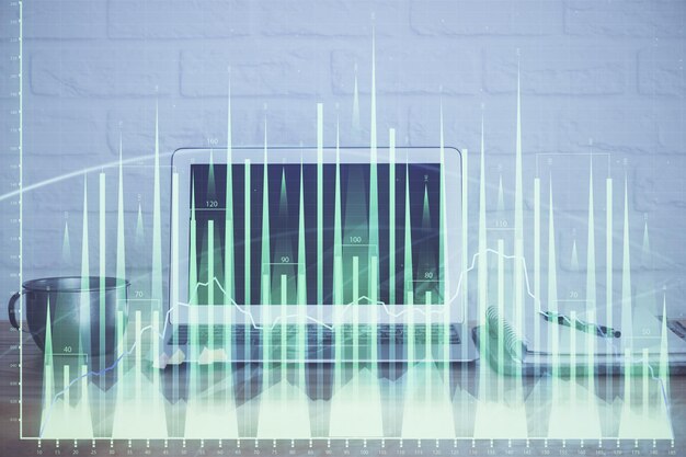 机とパソコンを背景に株式市場のグラフ マルチ露出 財務分析の概念