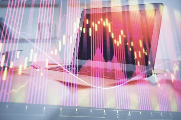 机とパソコンを背景に株式市場のグラフ マルチ露出 財務分析の概念