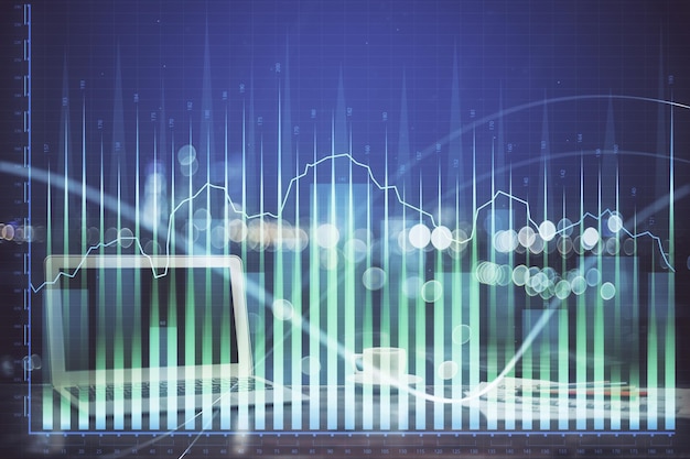 Stock market graph on background with desk and personal computer Multi exposure Concept of financial analysis