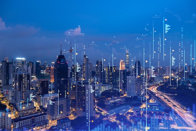 Stock market graph hologram night panorama city view of Kuala Lumpur KL is popular location to gain financial education in Malaysia Asia The concept of international research Double exposure