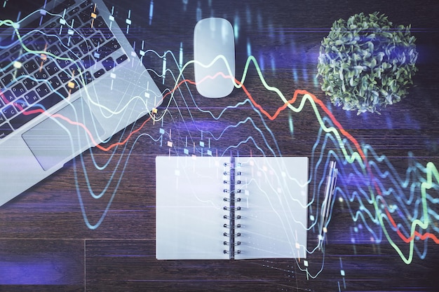 Stock market graph and top view computer on the table background Double exposure Concept of financial education