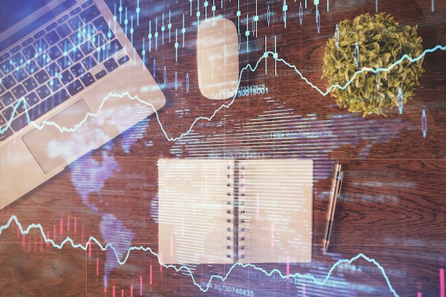 Stock market graph and top view computer on the table background Double exposure Concept of financial education