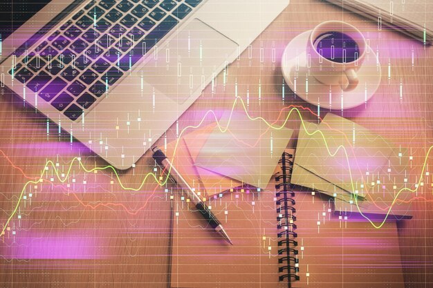 stock market graph and top view computer on the table background double exposure concept of financial education