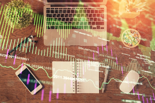 Stock market graph and top view computer on the table background Multi exposure Concept of financial education