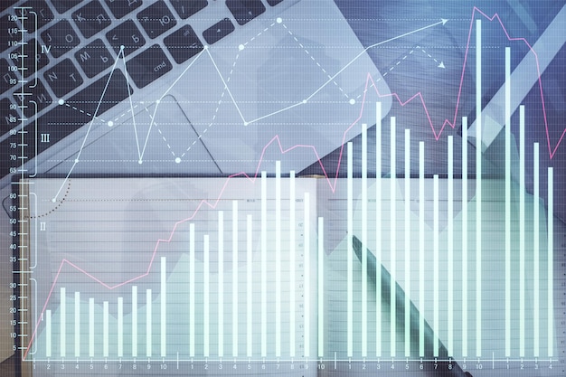 株式市場のグラフとトップビューのコンピュータを表の背景に マルチエクスポージャー 金融教育の概念