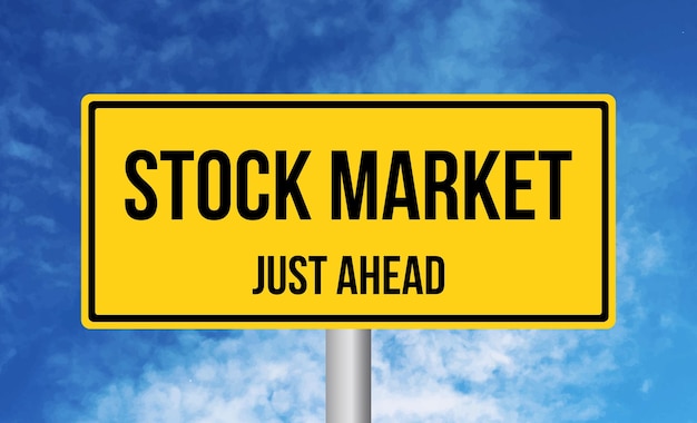 Stock market just ahead road sign on sky background