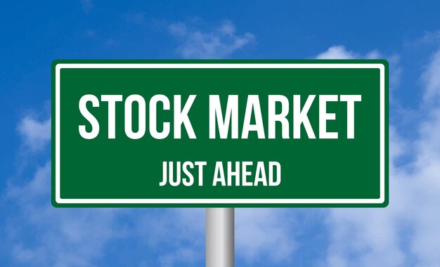 Photo stock market just ahead road sign on sky background