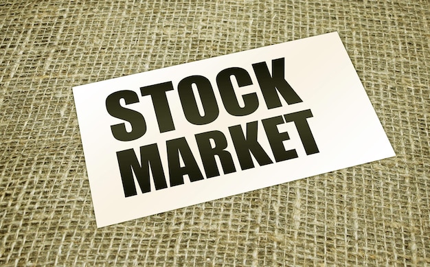 Photo stock market words on card on burlap canvas business concept