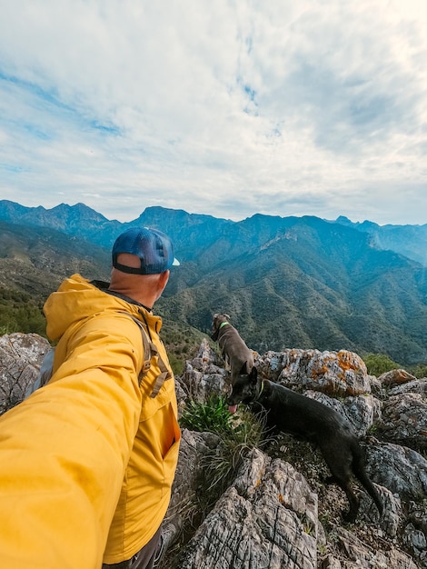 Stock photo of a man with his dog around the mountains