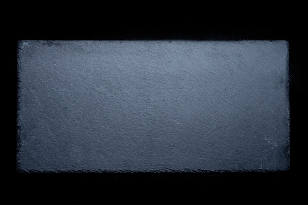 Stock photo of natural gray slate on black background.