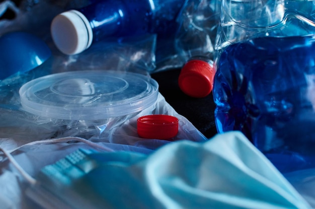 Stock photo of a pile of plastic waste symbolizing the concept of pollution and the environment on a black background