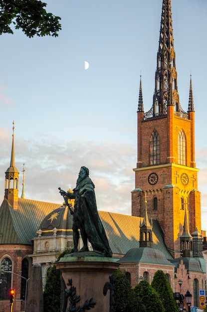 Stockholm Sweden City view A statue stands in front of a church with the moon Stockholm