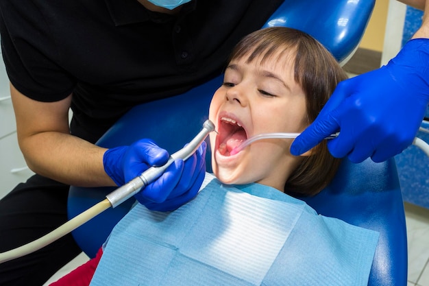 Stomatologist treating teeth of the child of the patient Medicine dentistry and healthcare concept