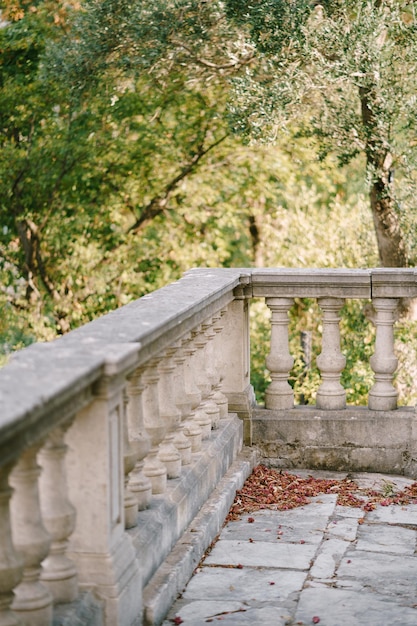 Stone balustrade on the terrace overlooking green trees