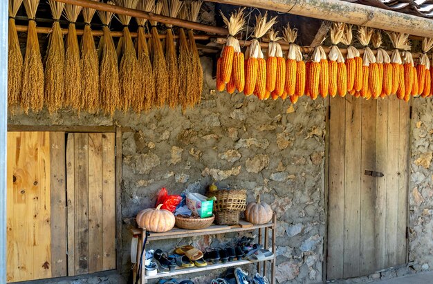 Stone barn with drying corn and straw photo