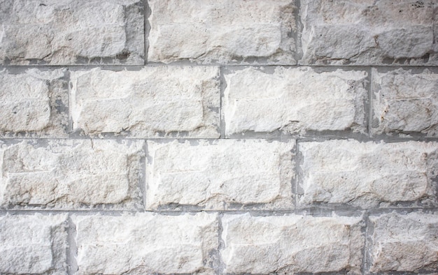 Stone blocks backgroundOld facing wallFacade cover light blocks