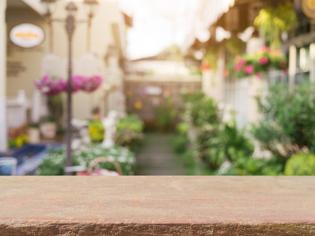 Photo stone board empty table in front of blurred background. perspective brown stone over blur in coffee shop - can be used for display or montage mock up your products. vintage filtered image.