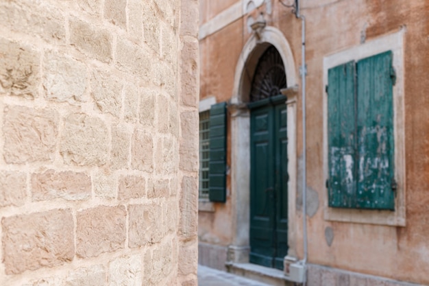 Stone brown wall against the background of the old town. background