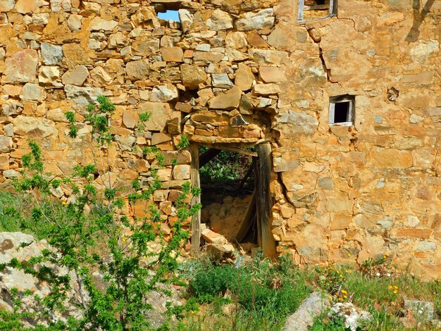 A stone building with a door that says'the word " on it