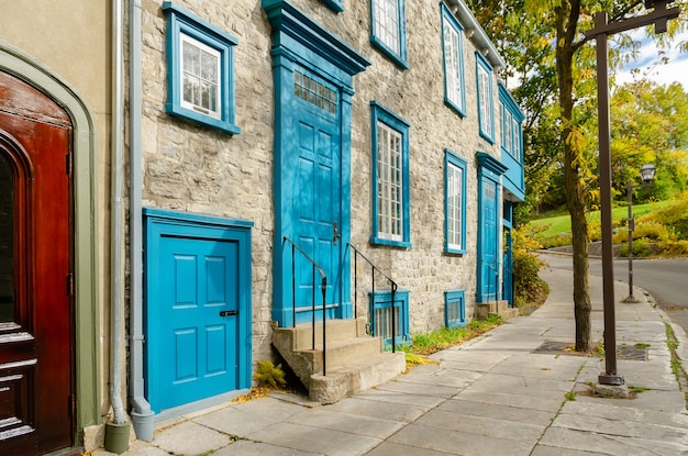 Stone buildings of Townhouse with blue shutters