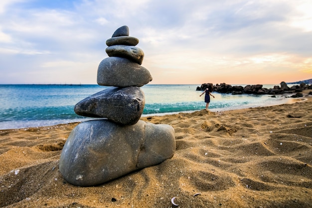 Stone cairn at the beach, concept of balance