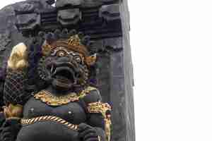 Photo stone carved demons protecting the staircase entrance of pura kehen hindu temple in bali indonesia