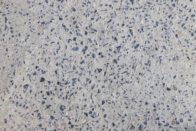 Stone in concrete closeup texture and cement abstract road fall background