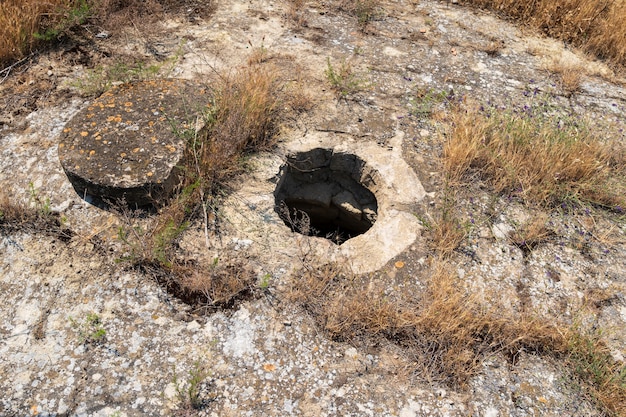 Stone cover and manhole of an ancient deep well