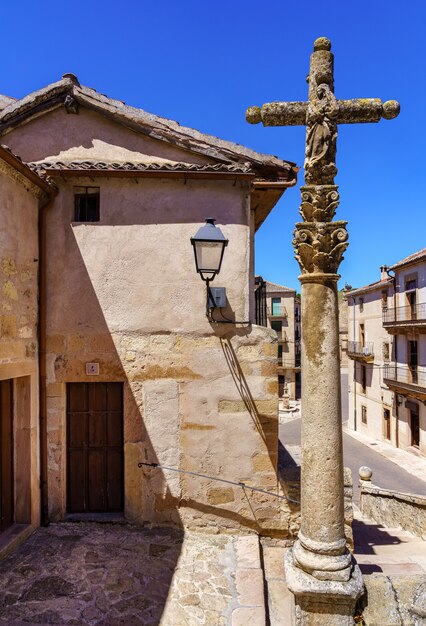 Stone cross in small square of medieval old town