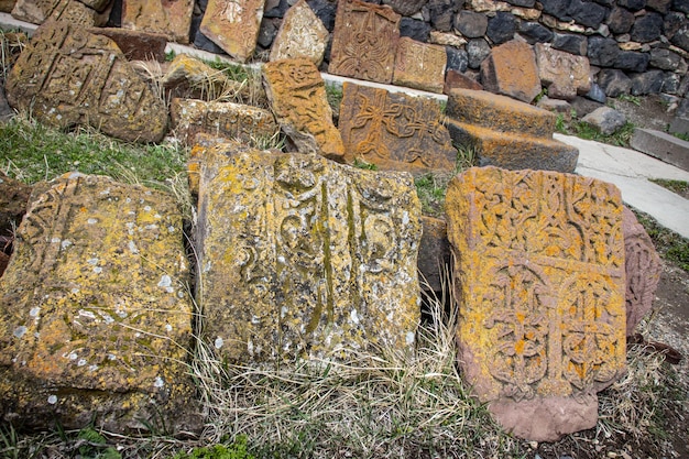 Stone cross with yellow lichen cover the rough stone concept photo