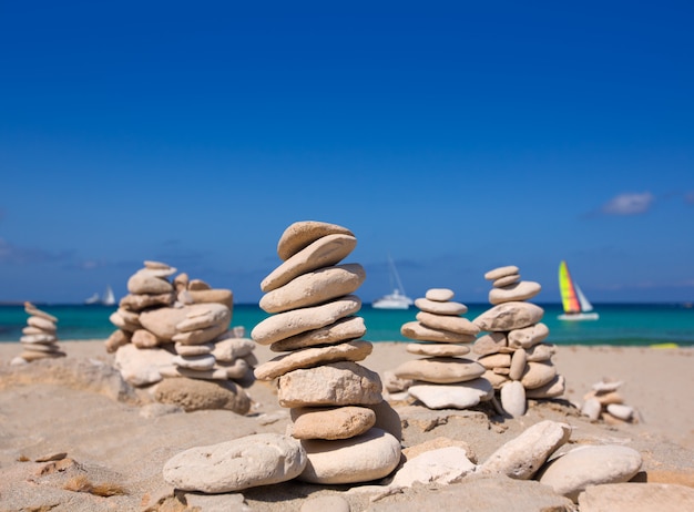 Stone figures on beach shore of Illetes beach in Formentera