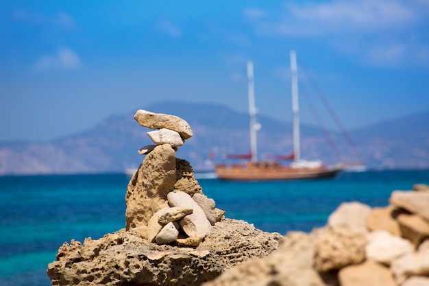Stone figures on beach shore of Illetes beach in Formentera