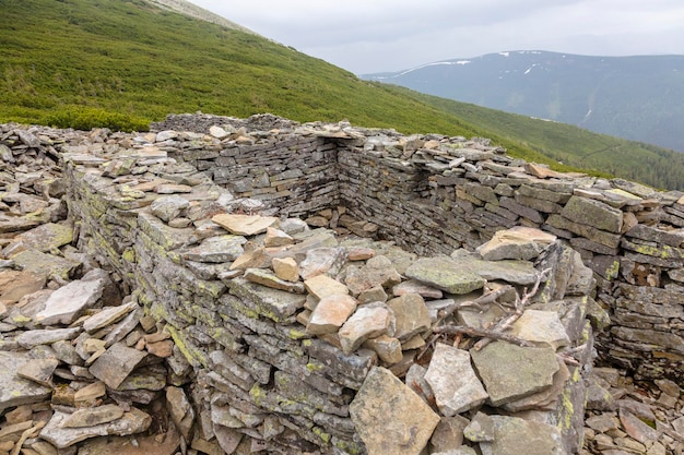 Stone fortification wall from the First World War covered with yellow moss Carpathians Ukraine