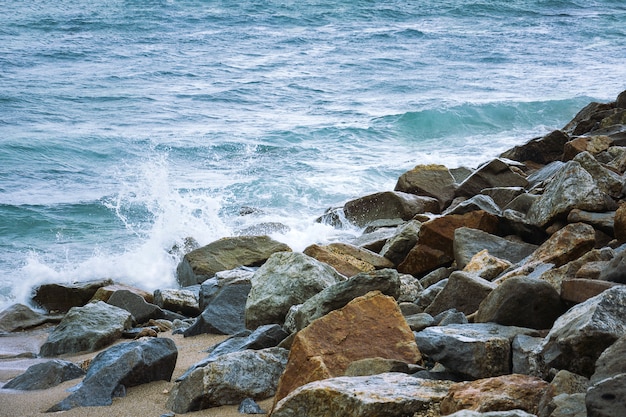 Stone In Green Sea With Wave