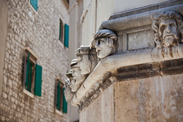 Stone heads at Cathedral of St. James in Sibenik, Croatia. UNESCO World Heritage Site